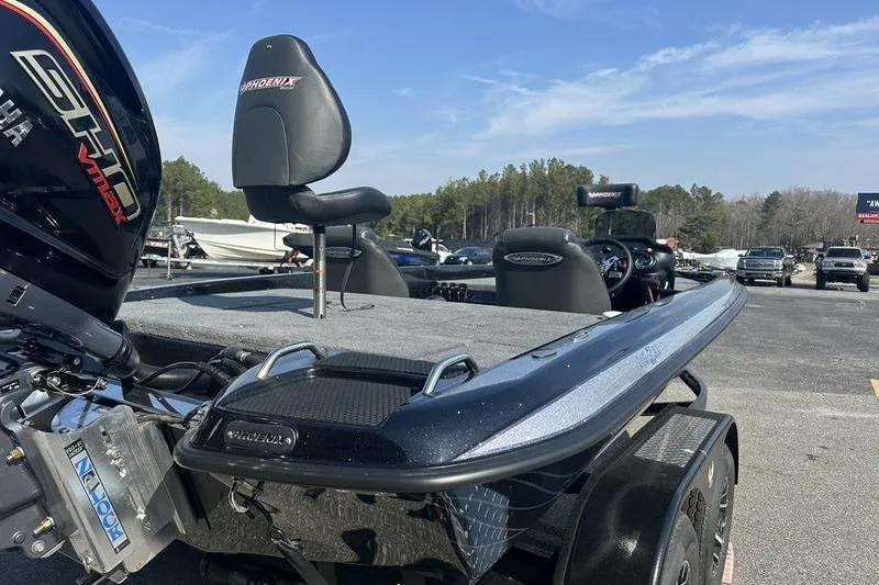 Slide: The Image of 2026 Phoenix 919 ZXL boat with Yamaha engine, parked outdoors under clear sky. - 5