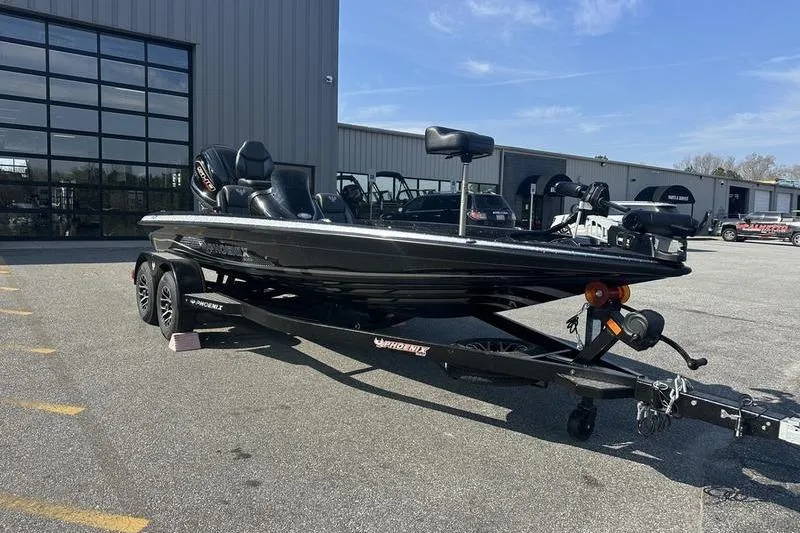 Slide: The Image of 2026 Phoenix 919 ZXL boat on trailer in parking lot, near industrial building. - 6