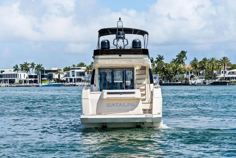 Slide: The Image of 2018 Monte Carlo MC 35 yacht cruising near luxury waterfront homes. - 11