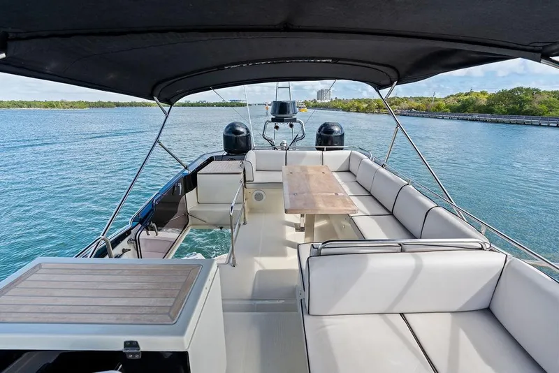 Slide: The Image of Luxurious 2018 Monte Carlo MC 35 yacht with spacious seating and scenic water view. - 15