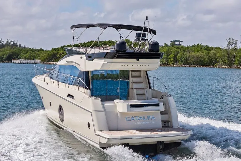 Slide: The Image of 2018 Monte Carlo MC 35 yacht cruising on a scenic waterway. - 2