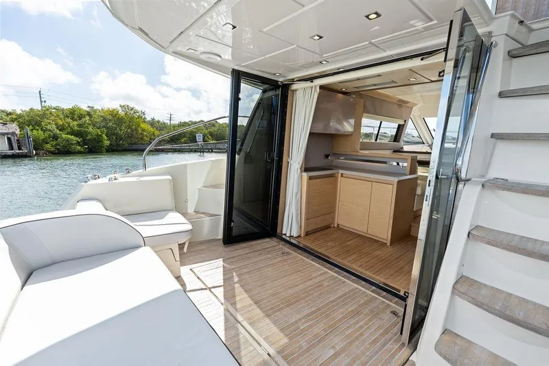 Slide: The Image of Luxurious 2018 Monte Carlo MC 35 yacht interior with open deck and modern kitchen. - 21