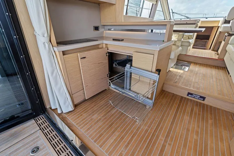 Slide: The Image of Luxurious 2018 Monte Carlo MC 35 yacht interior with modern kitchen and wooden flooring. - 23