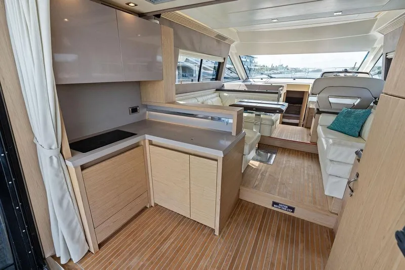 Slide: The Image of Luxurious interior of 2018 Monte Carlo MC 35 yacht with modern kitchen and seating area. - 24