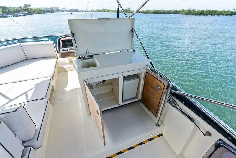 Slide: The Image of Luxurious Monte Carlo MC 35 yacht interior with kitchenette, 2018 model, overlooking serene waters. - 25