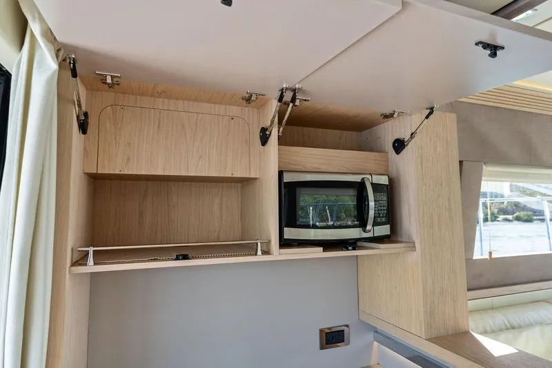 Slide: The Image of 2018 Monte Carlo MC 35 interior kitchen with microwave and open cabinets. - 30