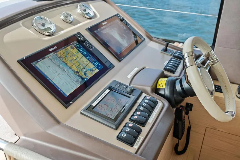 Slide: The Image of Control panel of 2018 Monte Carlo MC 35 yacht with navigation screens and steering wheel. - 38