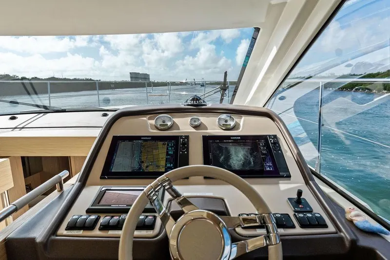 Slide: The Image of Cockpit view of 2018 Monte Carlo MC 35 yacht with navigation screens and steering wheel. - 40