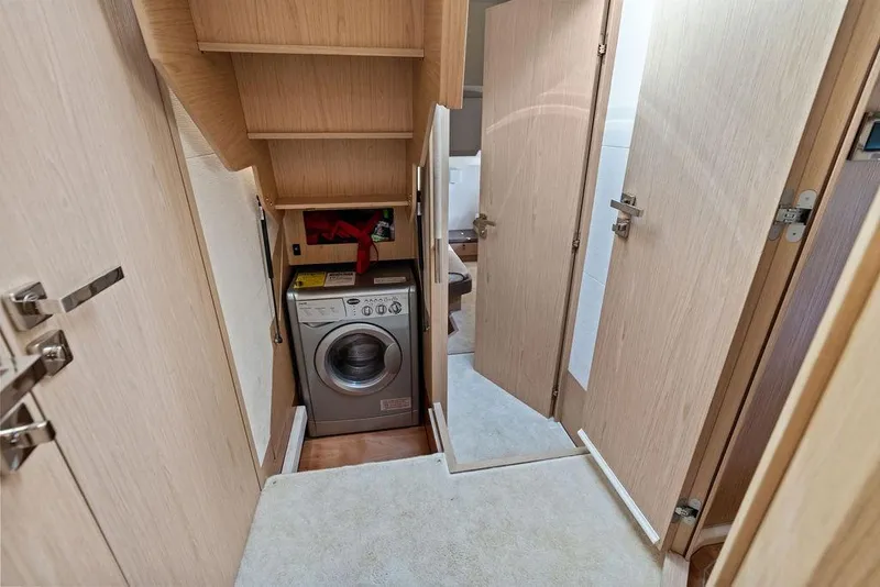 Slide: The Image of Laundry area inside 2018 Monte Carlo MC 35 yacht, featuring a compact washing machine. - 41