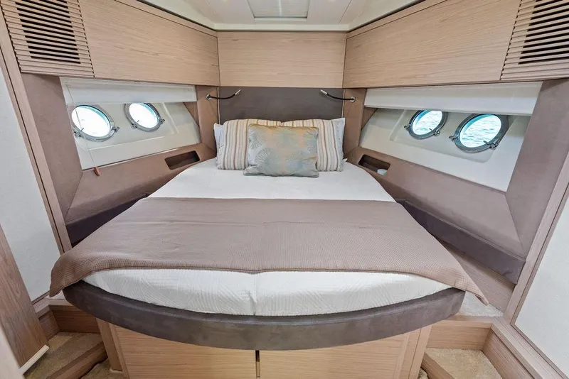 Slide: The Image of Luxurious 2018 Monte Carlo MC 35 yacht cabin with elegant bedding and porthole windows. - 42