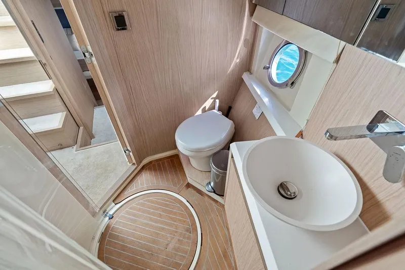 Slide: The Image of Luxurious 2018 Monte Carlo MC 35 yacht bathroom with modern fixtures and porthole view. - 45