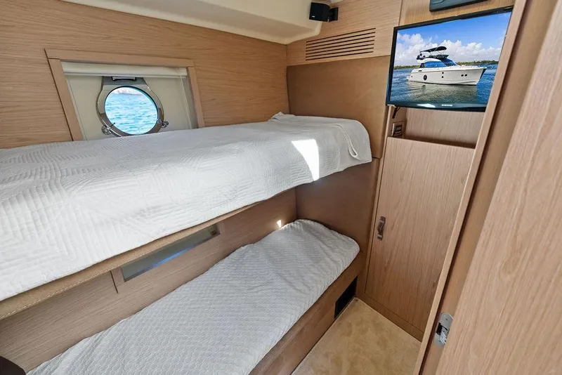 Slide: The Image of 2018 Monte Carlo MC 35 yacht cabin with bunk beds and porthole view. - 46