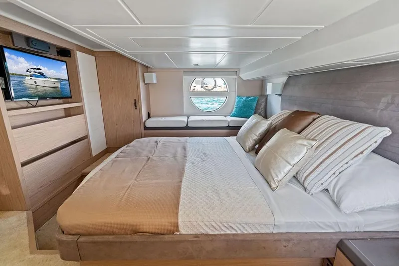 Slide: The Image of Luxurious Monte Carlo MC 35 yacht bedroom interior, featuring elegant bedding and a scenic window view. - 49