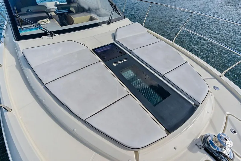 Slide: The Image of 2018 Monte Carlo MC 35 yacht deck with cushioned sunbathing area and sleek design. - 57