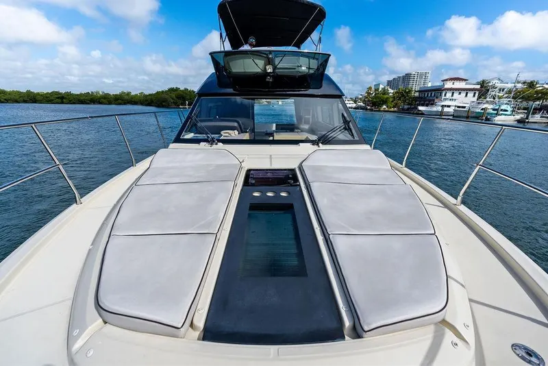 Slide: The Image of Luxurious 2018 Monte Carlo MC 35 yacht on serene water, featuring spacious sunbathing deck. - 58
