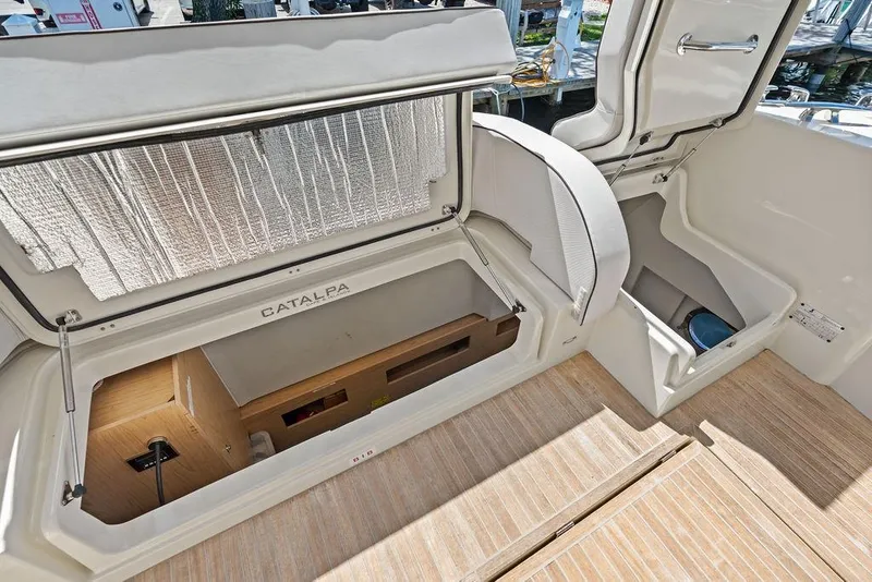 Slide: The Image of 2018 Monte Carlo MC 35 yacht interior with open storage compartments and wooden flooring. - 59