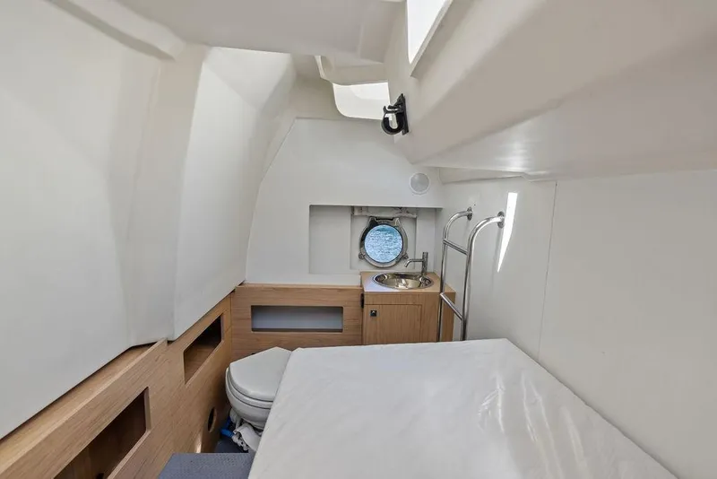 Slide: The Image of 2018 Monte Carlo MC 35 yacht interior with bed, sink, and porthole view. - 63