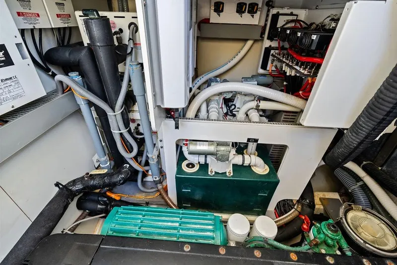 Slide: The Image of Engine room of a 2018 Monte Carlo MC 35 yacht, showcasing complex machinery and wiring. - 67