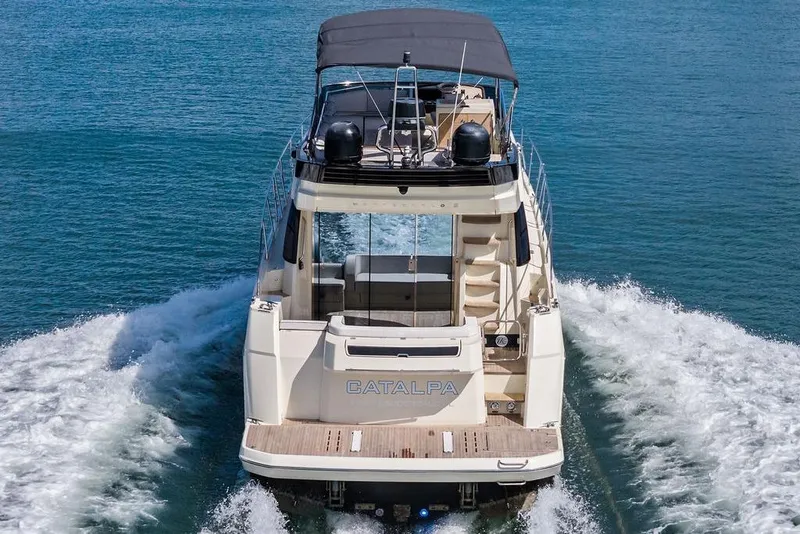 Slide: The Image of 2018 Monte Carlo MC 35 yacht cruising on open water, rear view. - 8