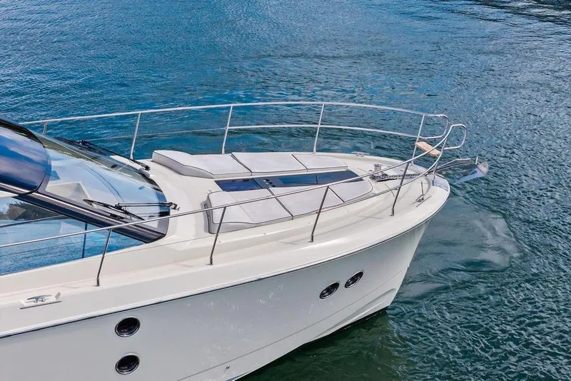 Slide: The Image of 2018 Monte Carlo MC 35 yacht on calm blue water, showcasing sleek design and luxury features. - 9