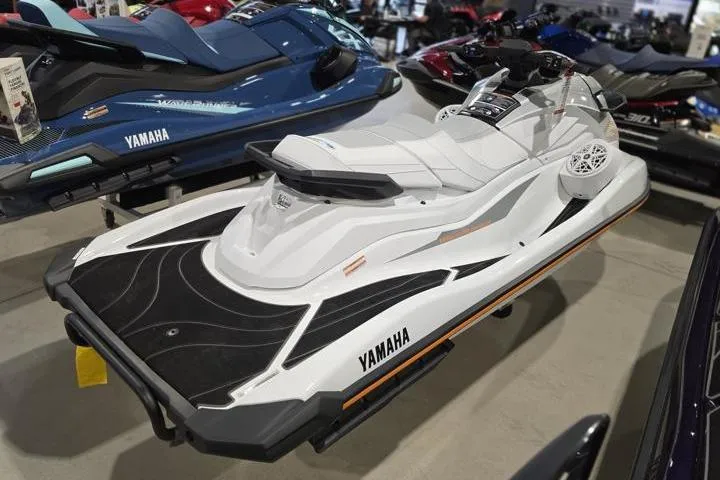 Slide: The Image of 2026 Yamaha WaveRunner GP HO jet ski in showroom, sleek white design. - 6