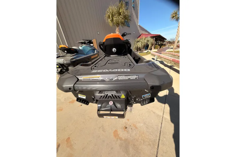 Slide: The Image of 2024 Sea-Doo GTR-X 300 jet ski, rear view, parked outdoors. - 2