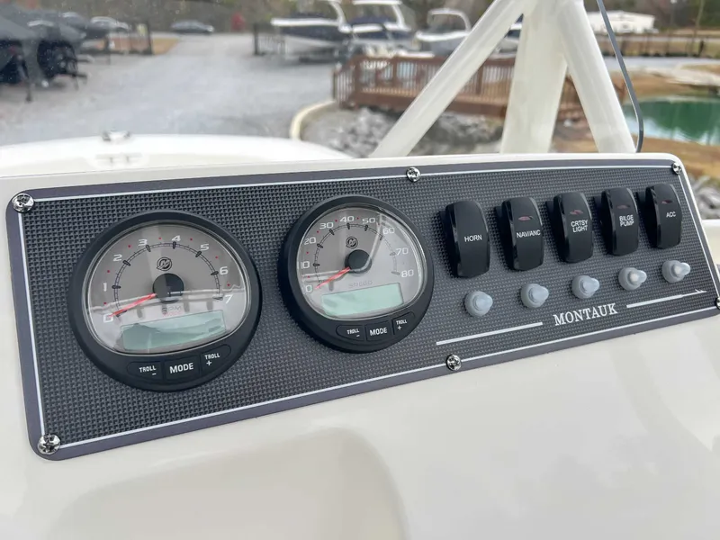 Slide: The Image of Dashboard of 2025 Boston Whaler 190 Montauk with switches and gauges. - 12