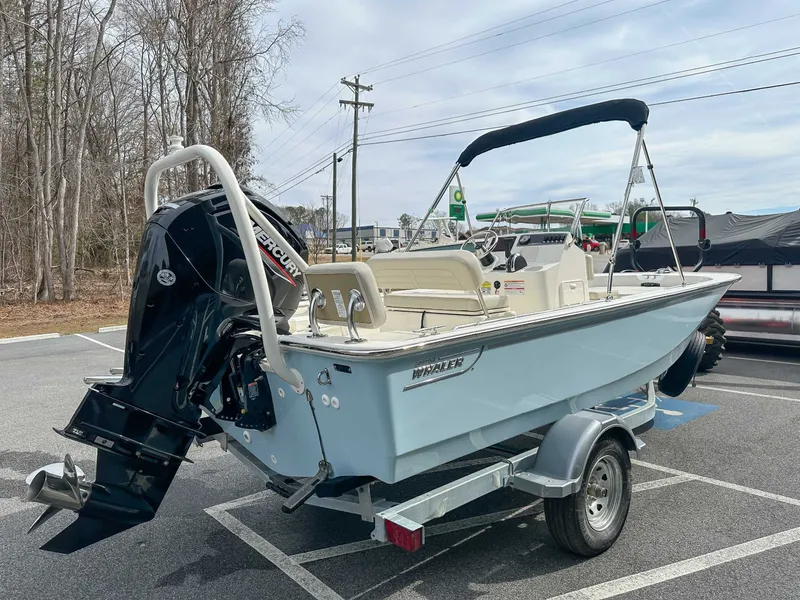 Slide: The Image of 2025 Boston Whaler 170 Montauk boat on trailer outdoors. - 7