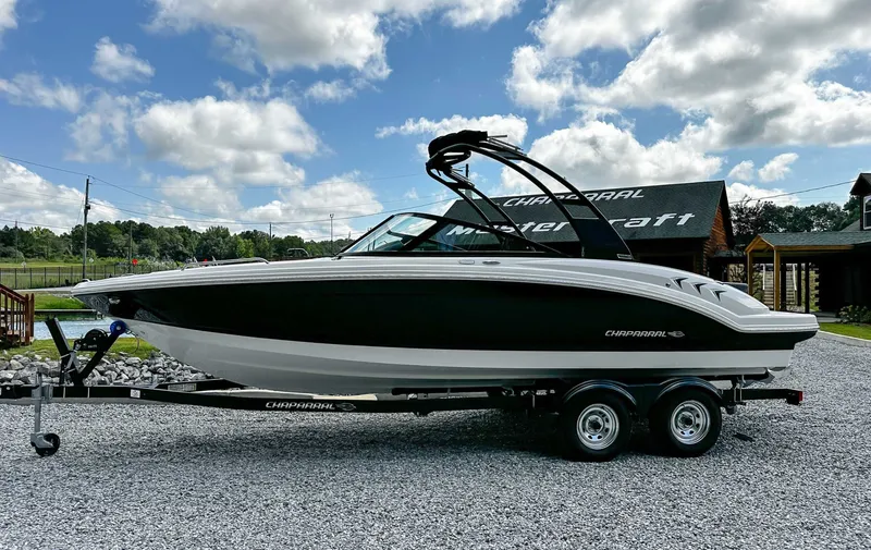 The Image of 2026 Chaparral 23 SSi boat on trailer under blue sky. - 1