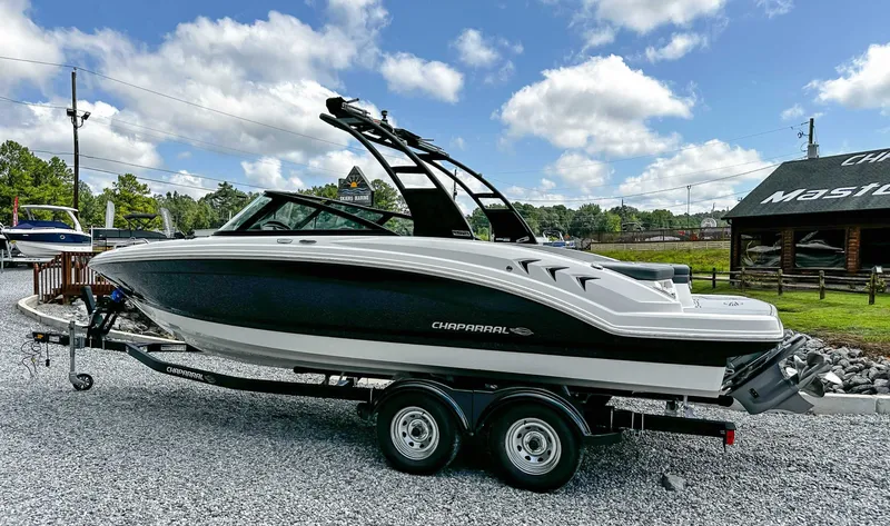 Slide: The Image of 2026 Chaparral 23 SSi boat on trailer, displayed outdoors. - 11