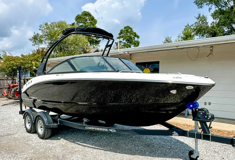 Slide: The Image of 2026 Chaparral 21 SSi boat on trailer, black, parked outdoors. - 5