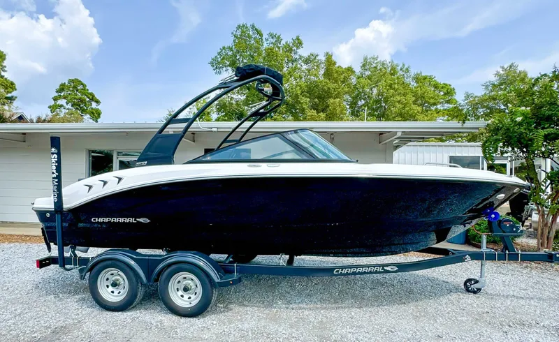 Slide: The Image of 2026 Chaparral 21 SSi boat on trailer in front of building. - 6