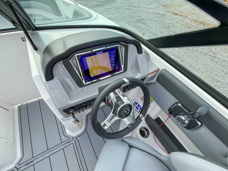 Slide: The Image of Interior of 2026 Chaparral 21 SSi with modern helm console. - 17