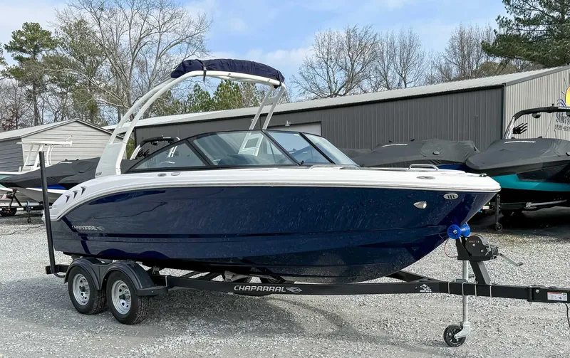 Slide: The Image of 2026 Chaparral 21 SSi boat on trailer, blue, parked outdoors. - 5