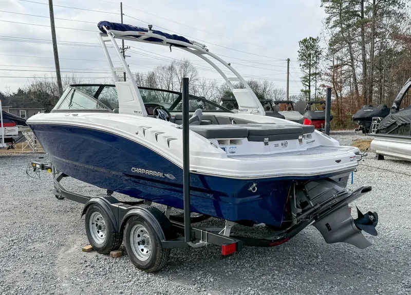 Slide: The Image of 2026 Chaparral 21 SSi boat on trailer, blue and white design. - 8