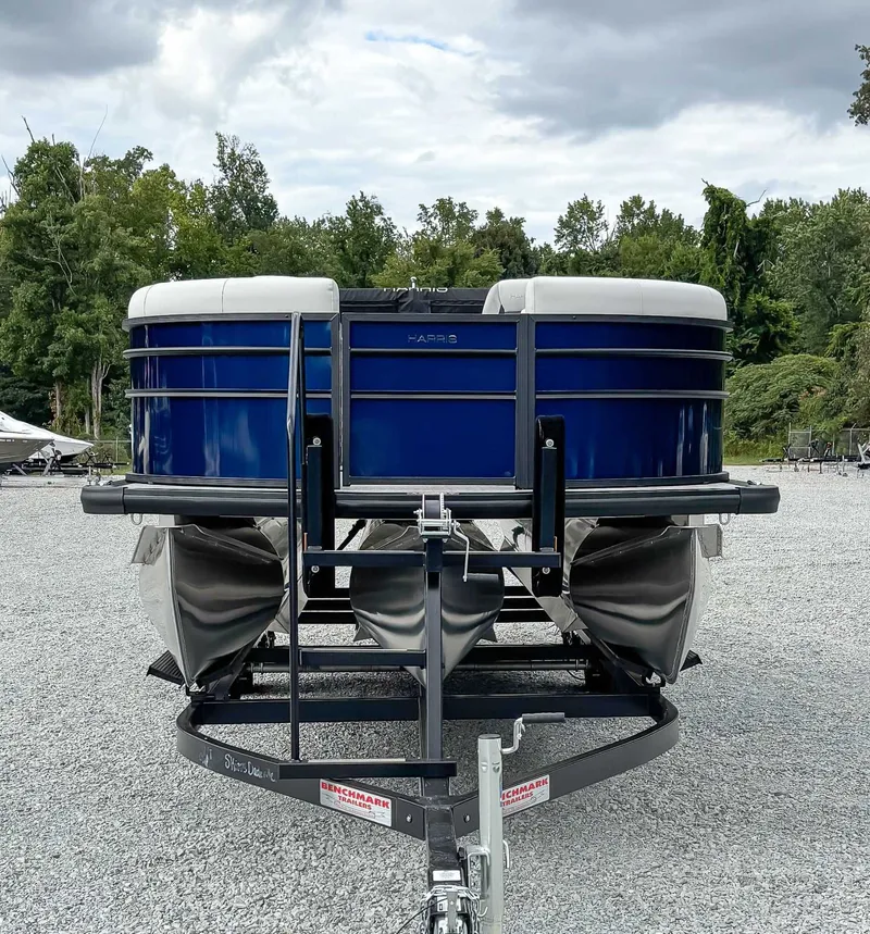 Slide: The Image of 2026 Harris Cruiser 230 SLDH boat on trailer, blue hull, gravel lot. - 3