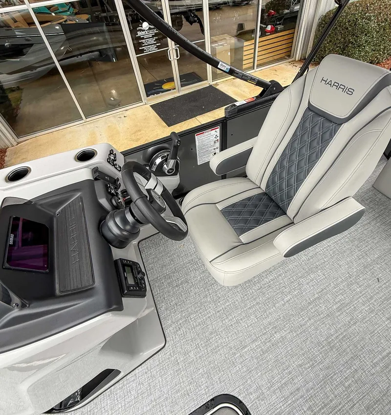 Slide: The Image of Interior of 2026 Harris Cruiser 230 SLDH with gray seat and helm. - 17