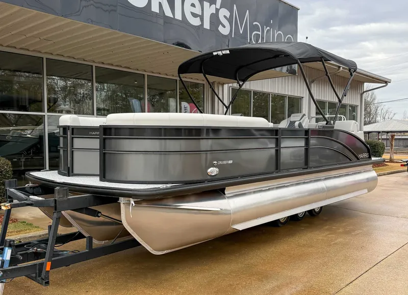 Slide: The Image of 2026 Harris Cruiser 230 SLDH pontoon boat outside a building. - 3