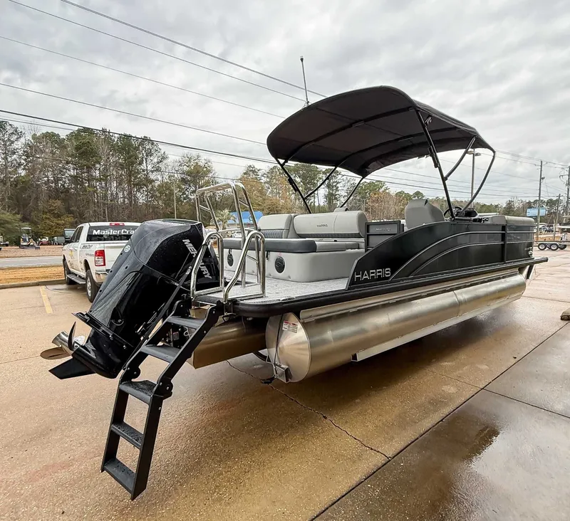 Slide: The Image of 2026 Harris Cruiser 230 SLDH pontoon boat with black canopy and motor. - 7