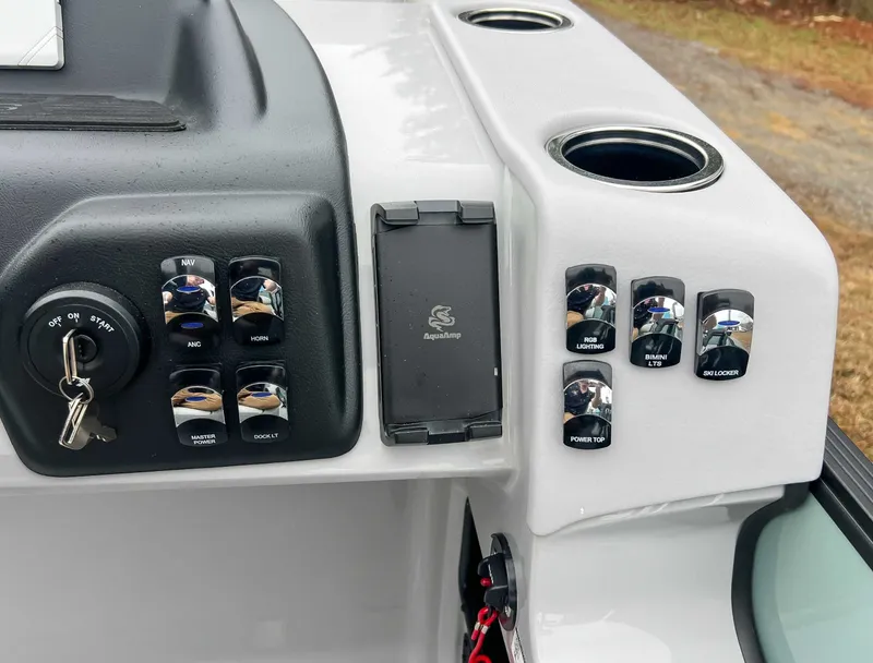 Slide: The Image of Dashboard of 2026 Harris Cruiser 230 SLDH with switches and ignition key. - 21