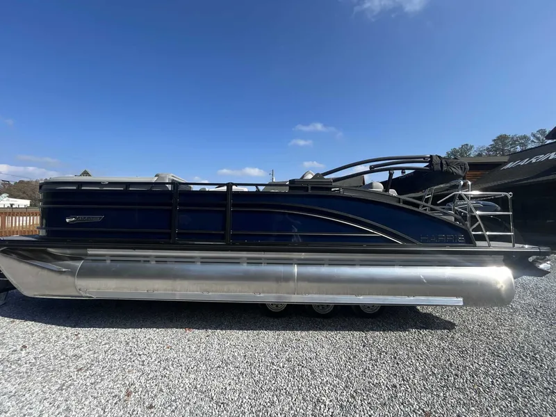 The Image of 2026 Harris Solstice 230 SLDH pontoon boat on gravel surface. - 1