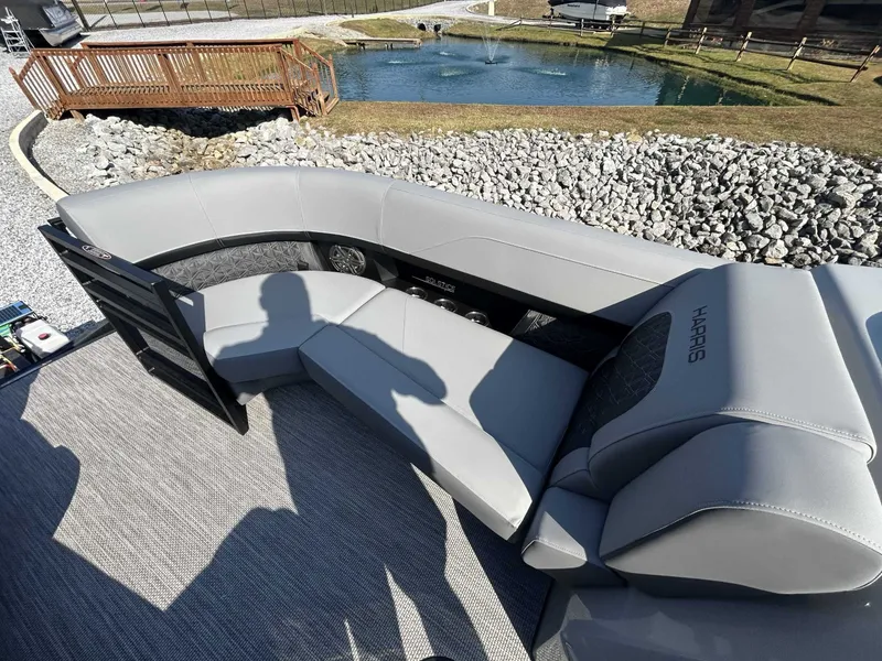 Slide: The Image of Harris Solstice 230 SLDH 2026 with gray seating by a pond. - 14