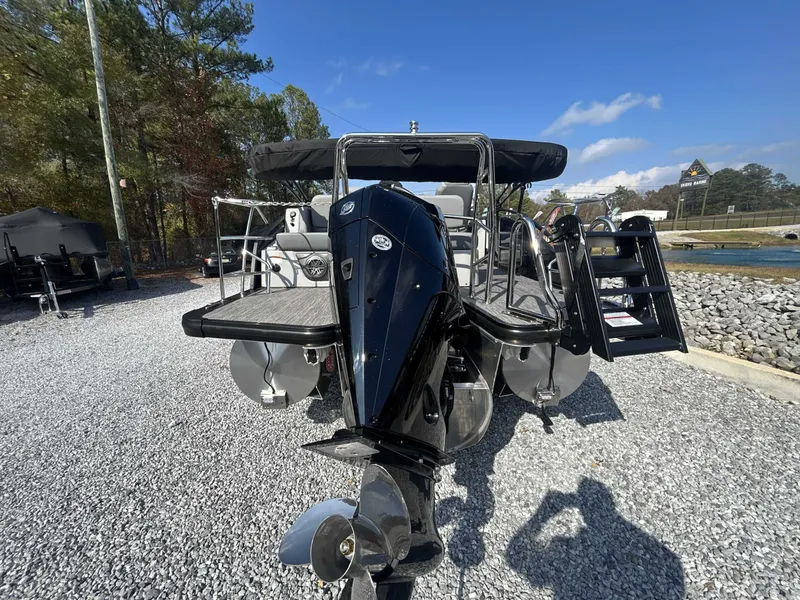 Slide: The Image of Harris Solstice 230 SLDH 2026 boat on gravel lot under sunny skies. - 18