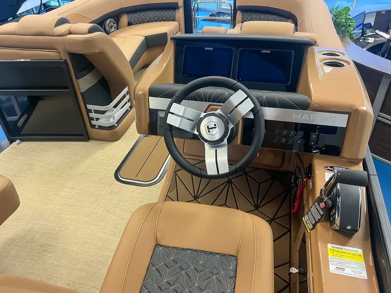 Slide: The Image of Interior of 2026 Harris Grand Mariner 230 SLDH with steering wheel and seats. - 19