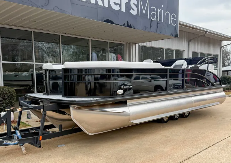 Slide: The Image of 2026 Harris Cruiser 250 SLDH pontoon boat outside a marine shop. - 3