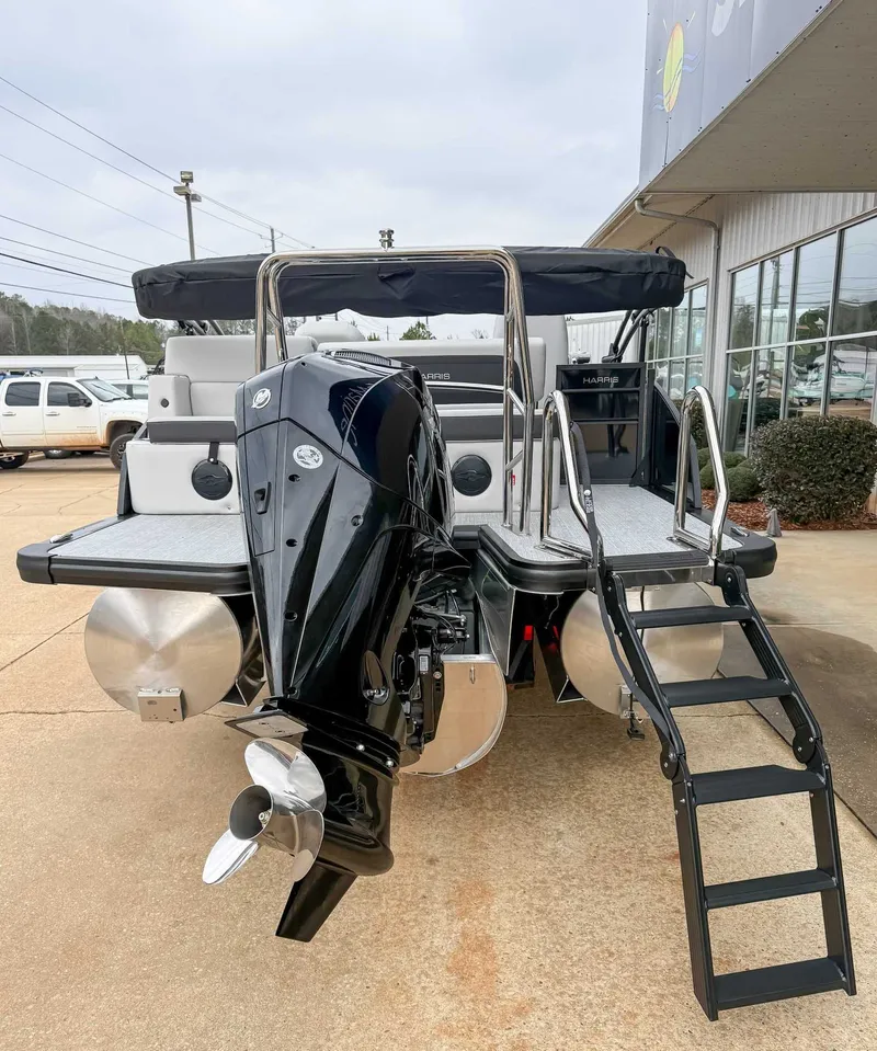Slide: The Image of 2026 Harris Cruiser 250 SLDH boat with outboard motor and ladder. - 8