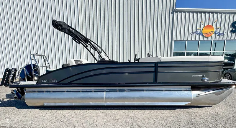 The Image of 2026 Harris Cruiser 230 SLDH pontoon boat in front of a building. - 1