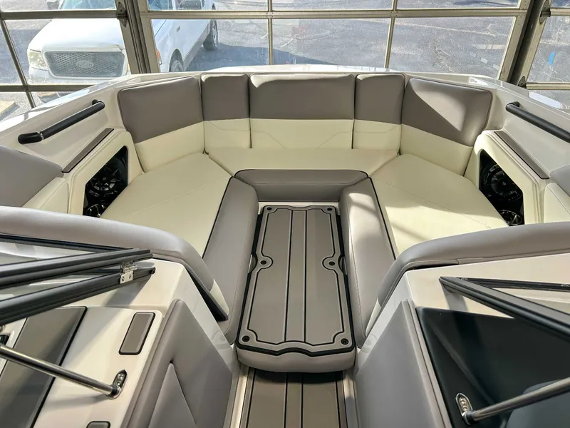 Slide: The Image of Interior of a 2025 Moomba Max boat with gray and white seating. - 12