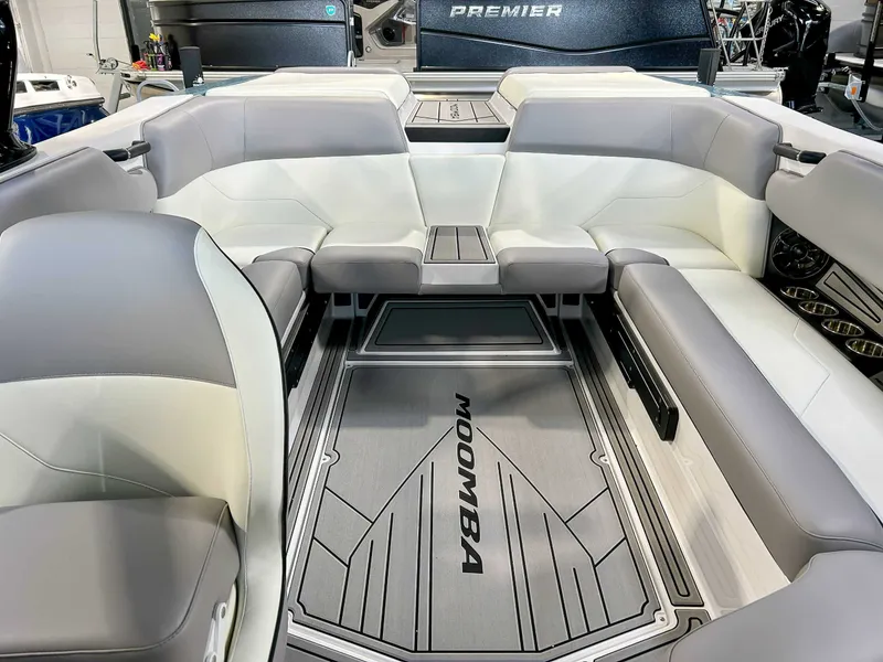 Slide: The Image of 2025 Moomba Max boat interior with gray and white seating. - 16