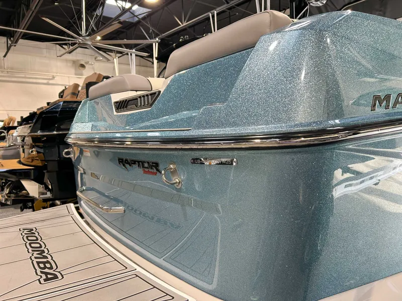 Slide: The Image of 2025 Moomba Max boat with Raptor engine in a showroom. - 5